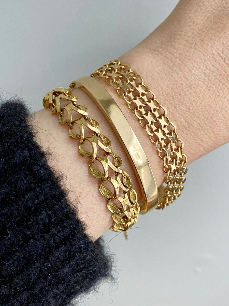 18k gold vintage swedish hinged bangle bracelet stacked with chain bracelets