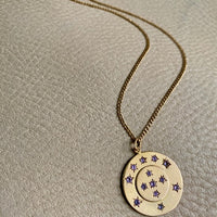13 stone stars in circles within a solid 18k gold pendant