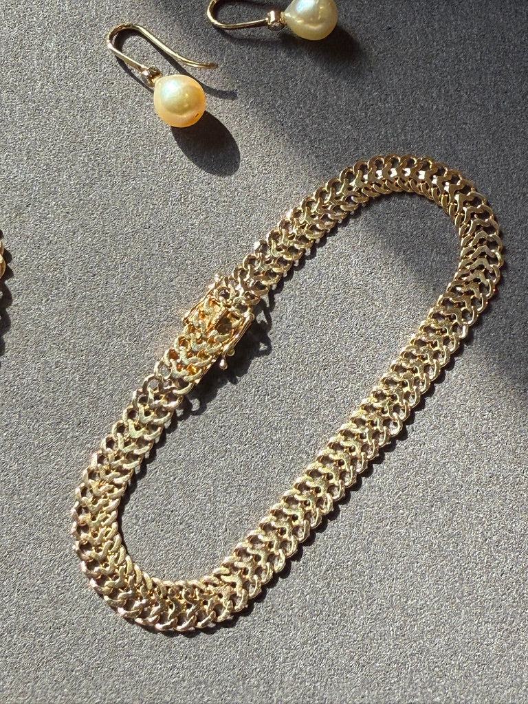 18k gold vintage bracelet on gray background