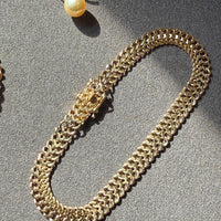 18k gold vintage bracelet on gray background