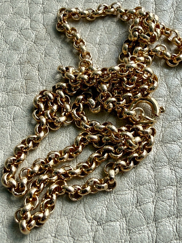 18k gold vintage rolo chain necklace on a textured light gray surface