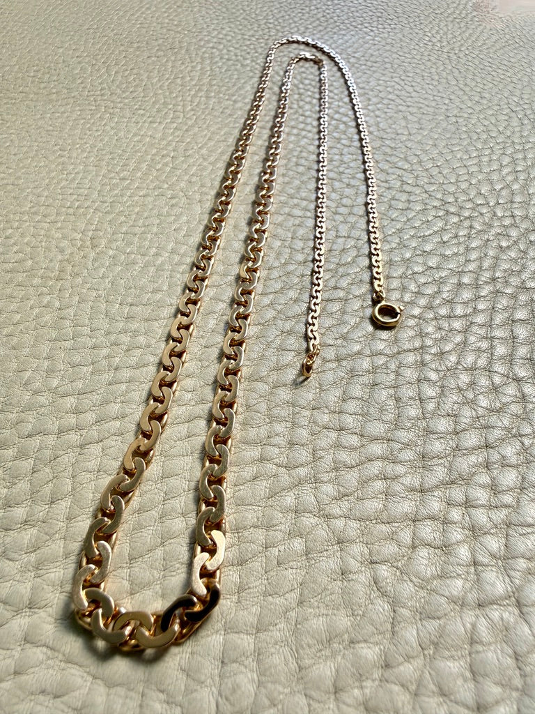 18k Gold vintage chain necklace on a textured light gray surface