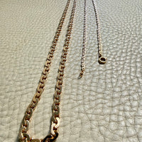 18k Gold vintage chain necklace on a textured light gray surface
