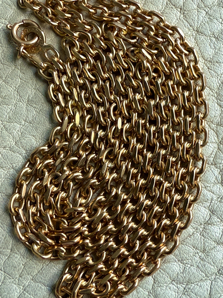 Gold chain on a textured light background