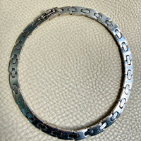 Silver bracelet on a textured beige surface