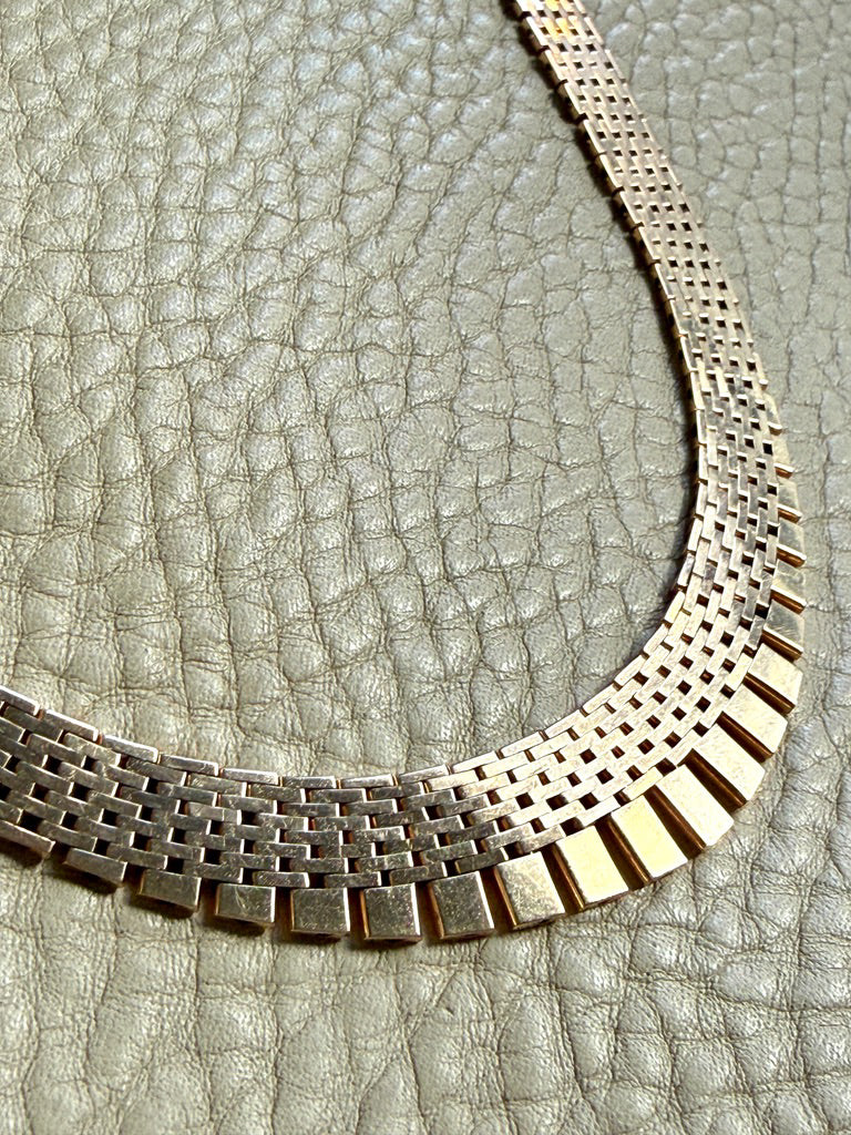 14k gold vintage cleopatra necklace on a textured gray surface penelopepenelope.com