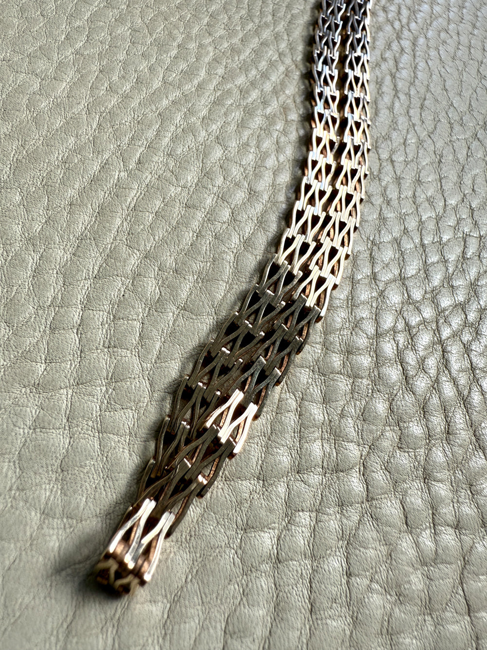 gold chain necklace on a textured gray surface