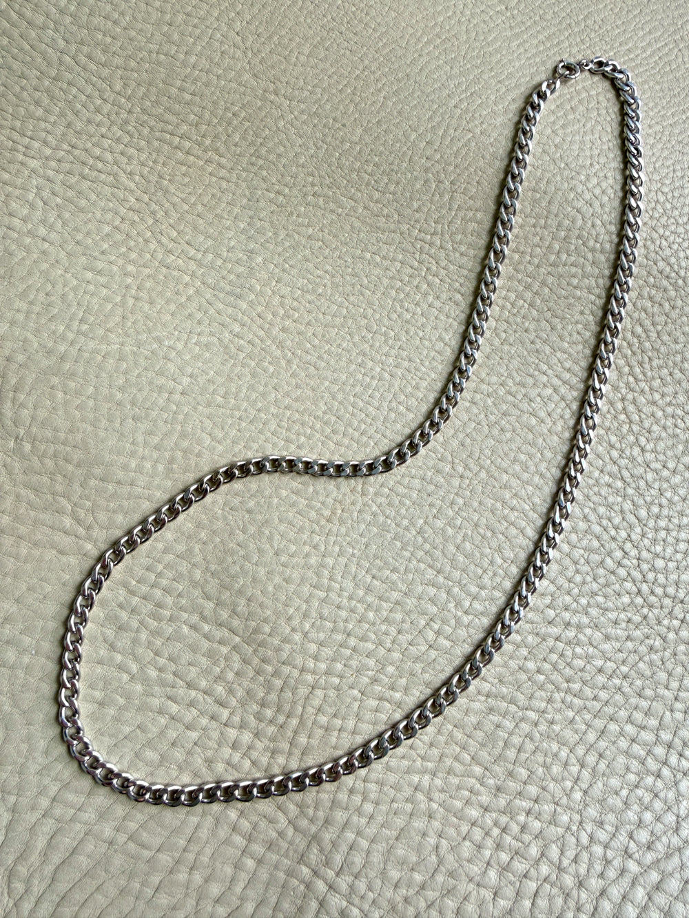 vintage 14k white gold chain  necklace on a textured beige surface