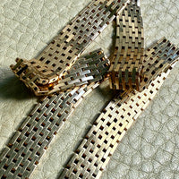 14k gold vintage cleopatra necklace on a textured surface