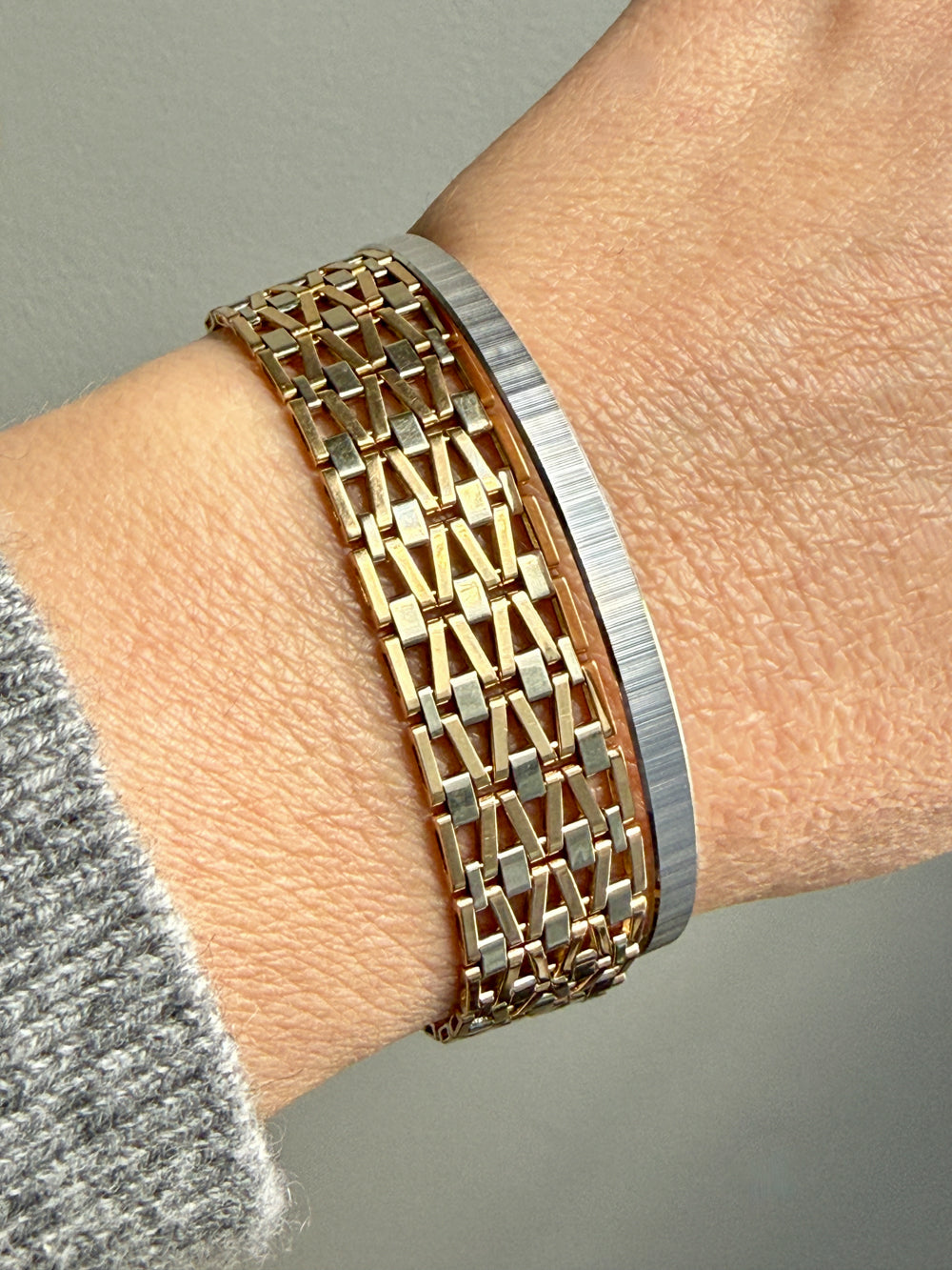 vintage 18k Gold link bracelet and white gold bangle on a wrist 