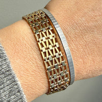 vintage 18k Gold link bracelet and white gold bangle on a wrist 