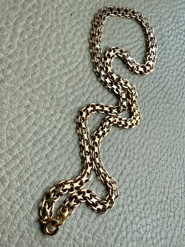 Gold chain on a textured gray surface