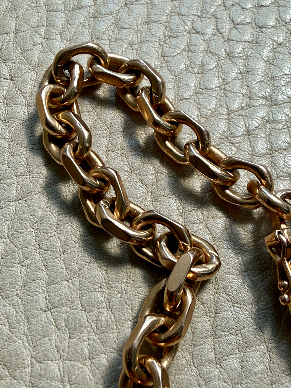 18k gold vintage biker link chain bracelet on gray textured surface penelopepenelope.com