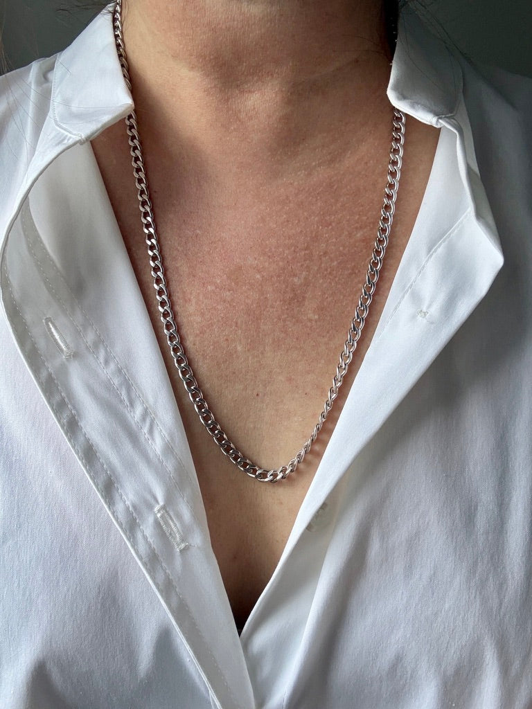 14k white gold chain necklace worn by a person in a white shirt