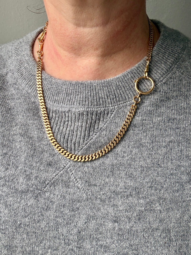 18k Gold watch chain necklace on a person wearing a gray sweater