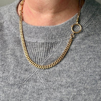 18k Gold watch chain necklace on a person wearing a gray sweater