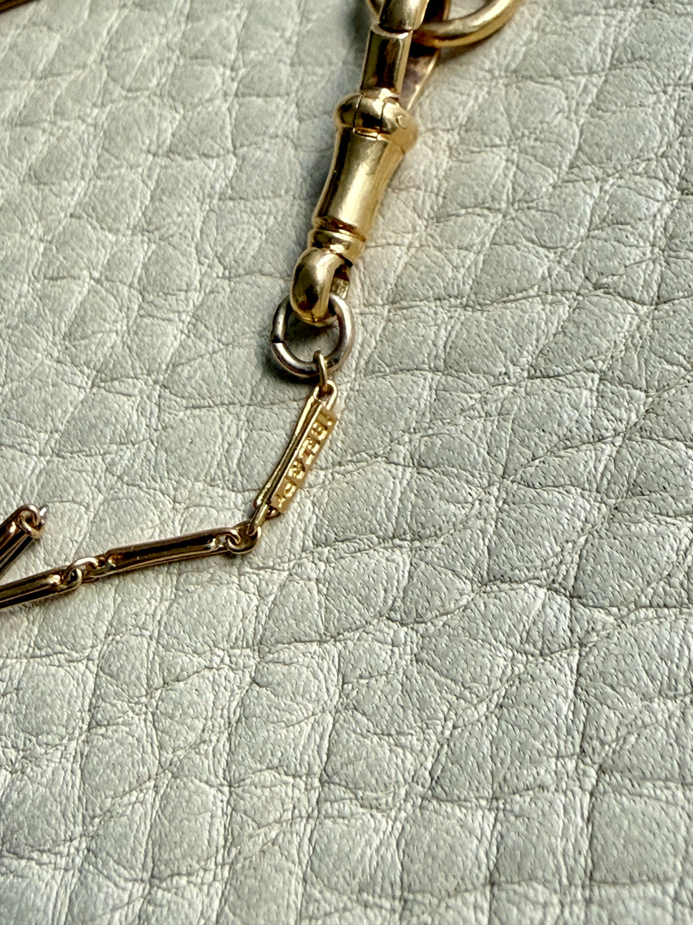 Gold link on a textured light gray surface