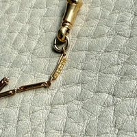 Gold link on a textured light gray surface