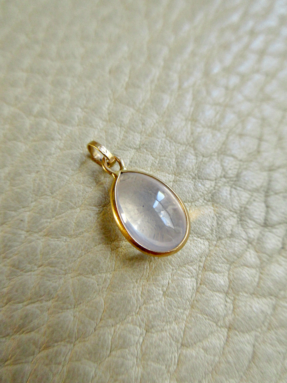Vintage 18k Gold Teardrop Moonstone Charm - 0.75 inch drop on beige background