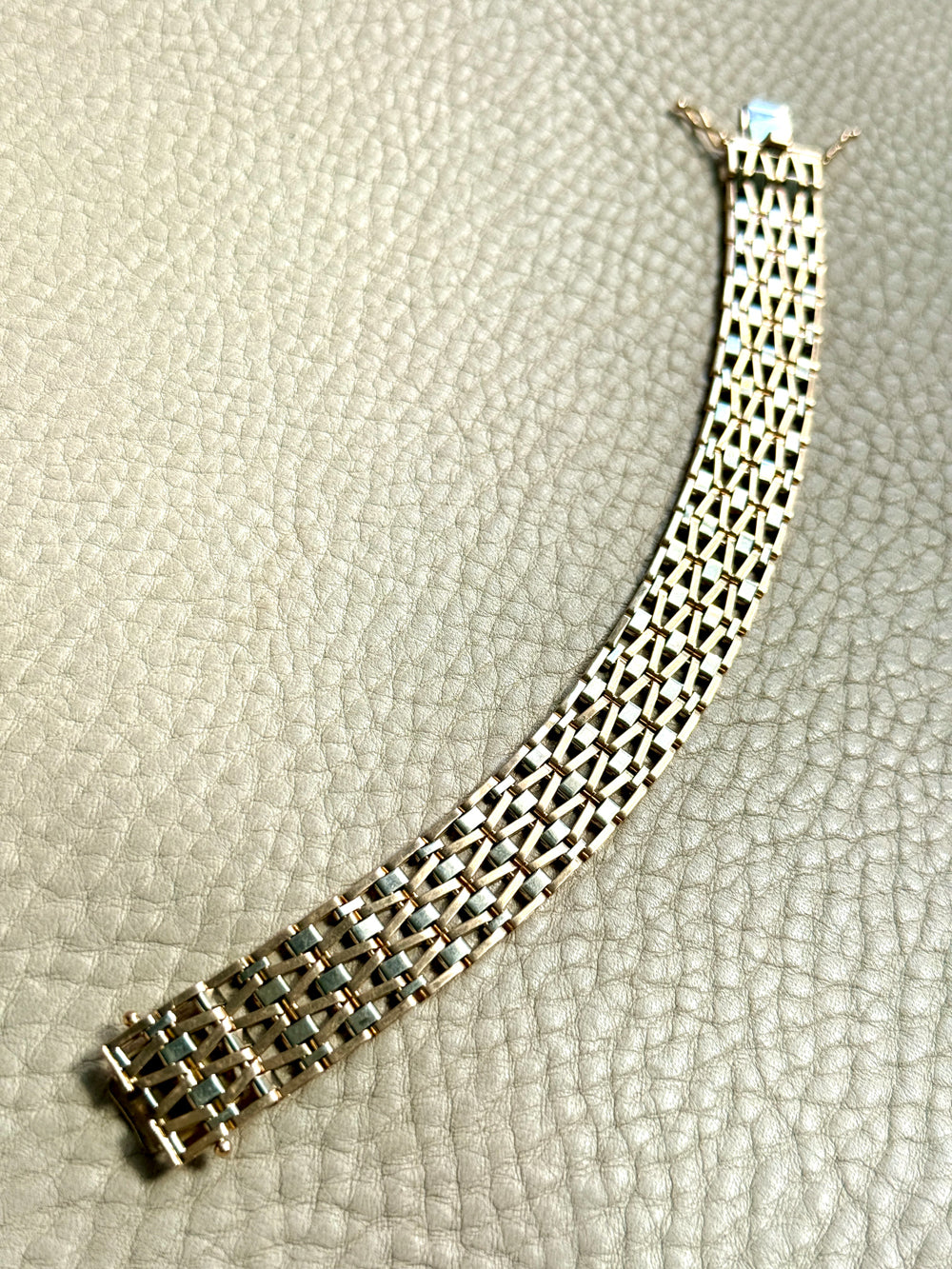 vintage 18k Gold link bracelet with a woven pattern on a textured surface