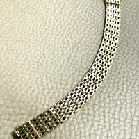 vintage 18k Gold link bracelet with a woven pattern on a textured surface