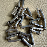 vintage silver necklace on a textured beige surface