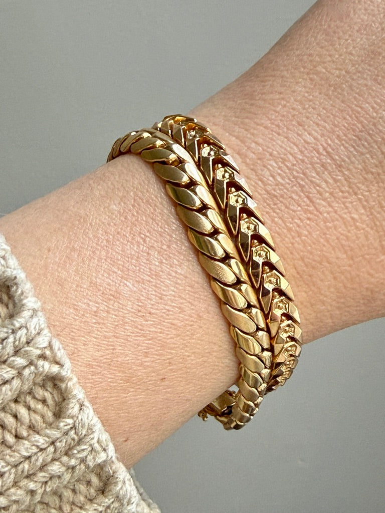 2 vintage Gold link bracelets on a wrist with a neutral background penelopepenelope.com