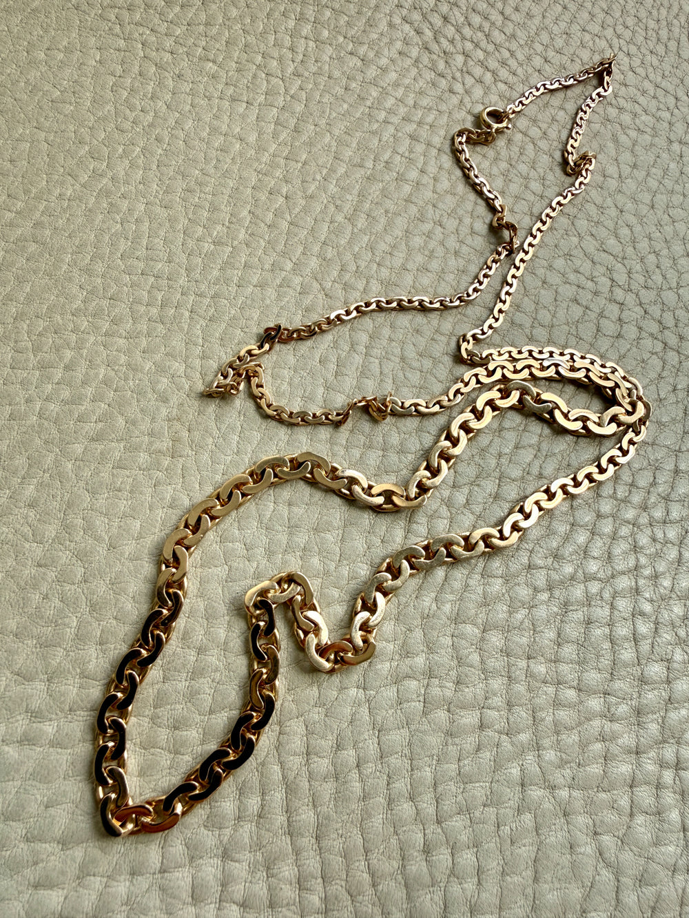 vintage 18k Gold virola link necklace on a textured light beige surface penelopepenelope.com