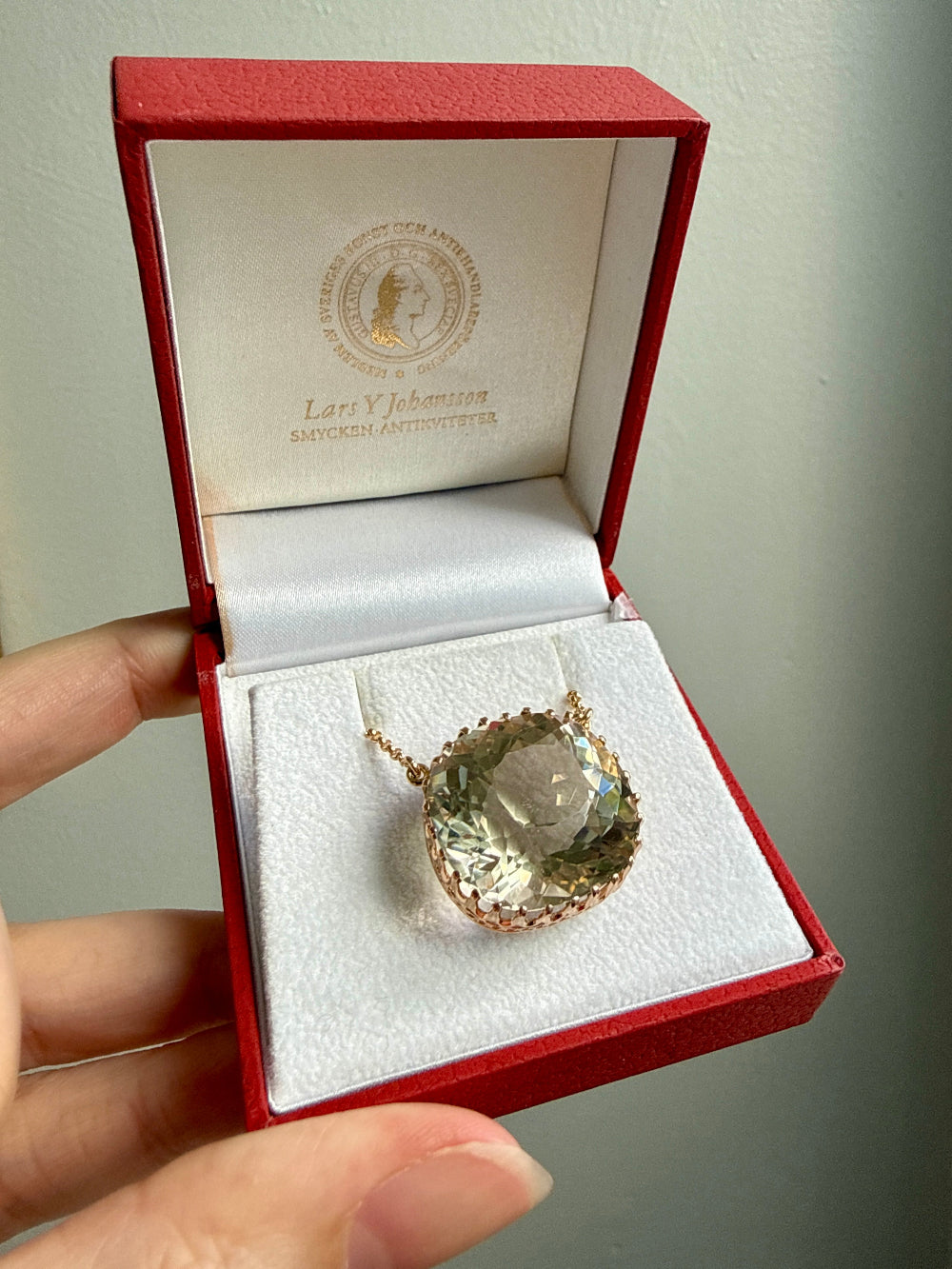 Necklace with a large smoky quartz gemstone in a red jewelry box