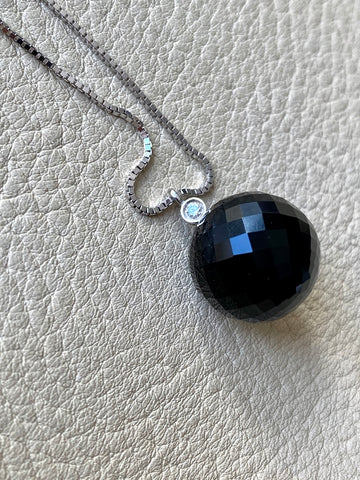 Brilliant! Black onyx faceted orb pendant necklace set in 18k white gold with 0.05 ct brilliant cut diamond by Ole Lynggaard