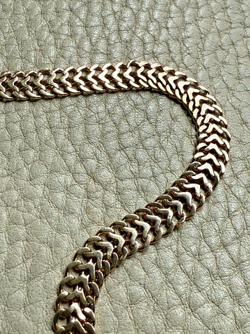 gold chain on a textured gray surface