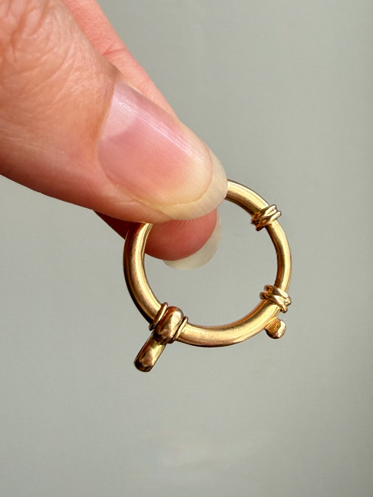 Antique Oversized Watch Chain Bolt Clasp in 18k Gold held between fingers
