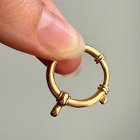 Antique Oversized Watch Chain Bolt Clasp in 18k Gold held between fingers