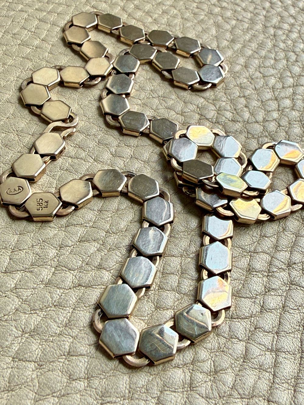 vintage 14k gold Necklace with hexagonal link on a textured beige surface penelopepenelope.com