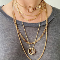 Stack of solid gold vintage chains on the neck