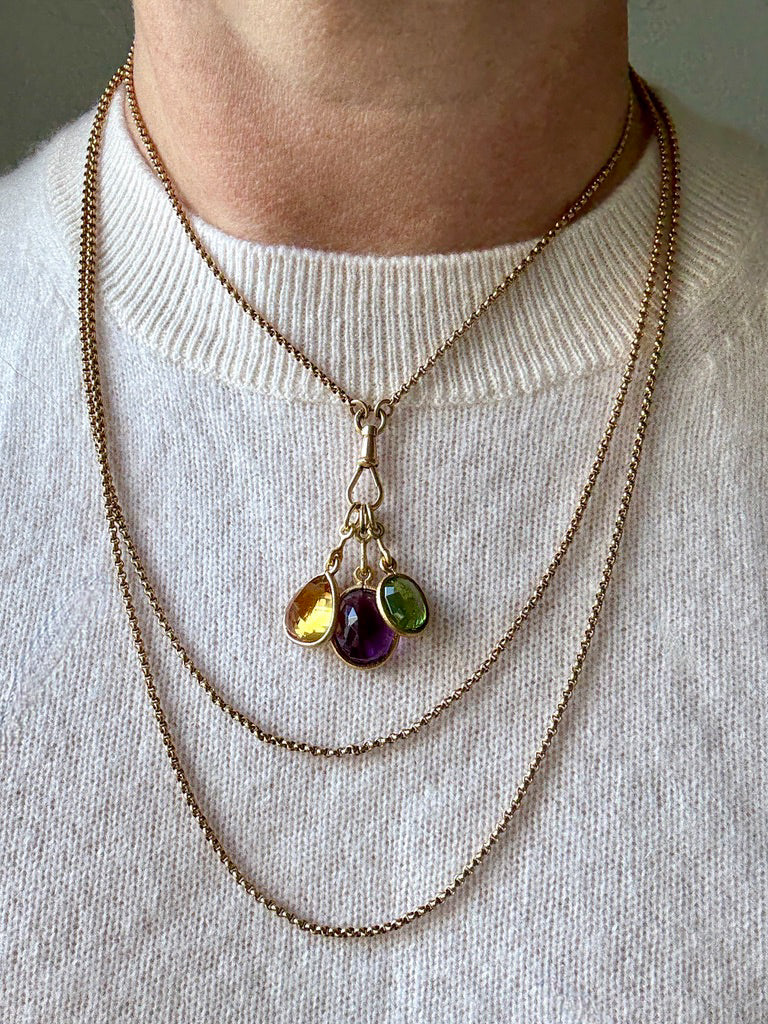 Necklace with colorful gemstones on a white sweater