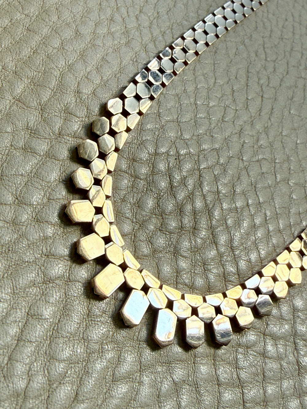 Necklace with geometric beads on a textured surface