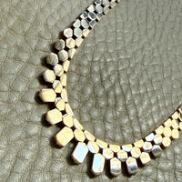 Necklace with geometric beads on a textured surface