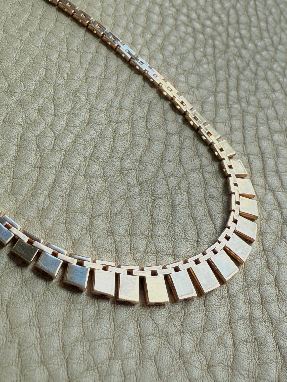 Vintage cleopatra 14k gold Necklace with square links on a textured surface