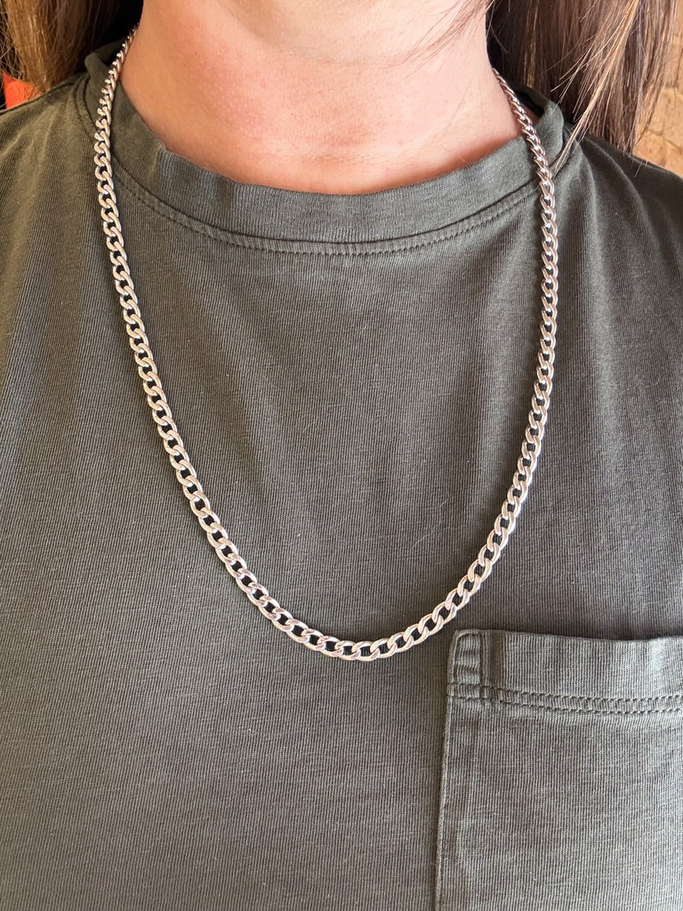 vintage 14k white gold chain necklace on a person wearing a green shirt.
