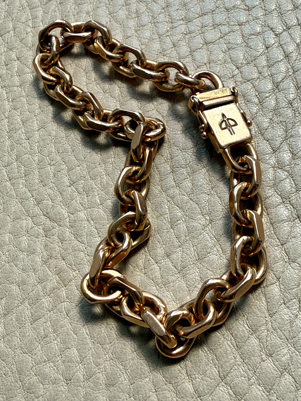 18k gold vintage biker link chain bracelet on gray textured surface penelopepenelope.com