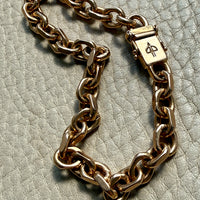 18k gold vintage biker link chain bracelet on gray textured surface penelopepenelope.com