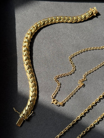 vintage gold link fine jewelry on tray