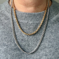 vintage gold necklaces on a person wearing a gray sweater