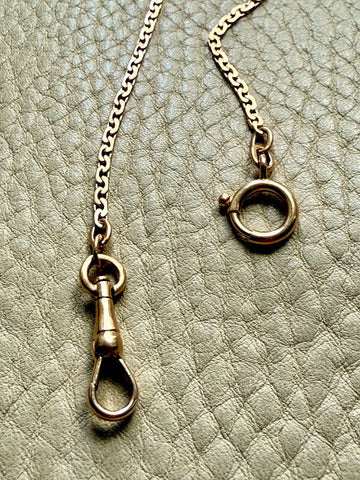 Close-up of a necklace with clasp on a textured surface