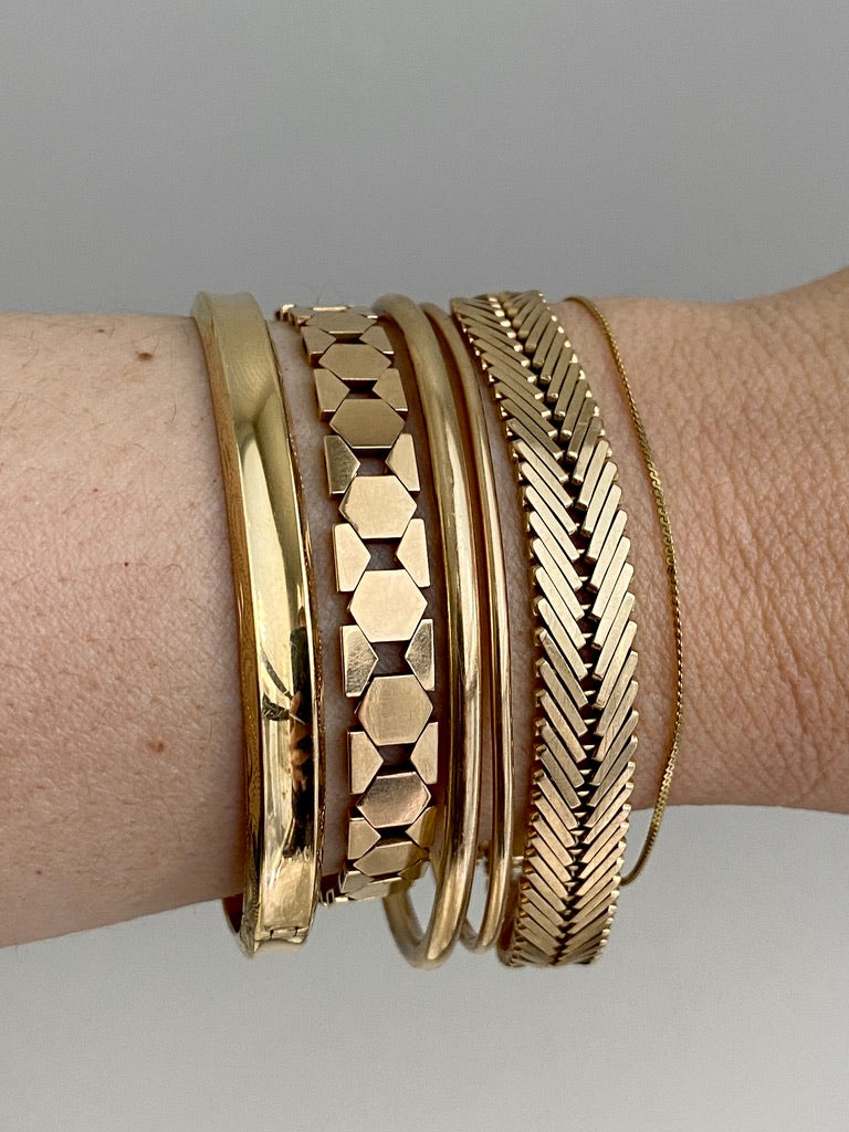 Stack of vintage 14k gold bracelets from Scabby Robot shop