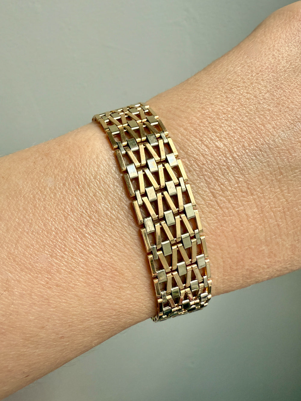 Gold bracelet on a wrist with a neutral background. Penelope Penelope Vintage Gold Jewelry