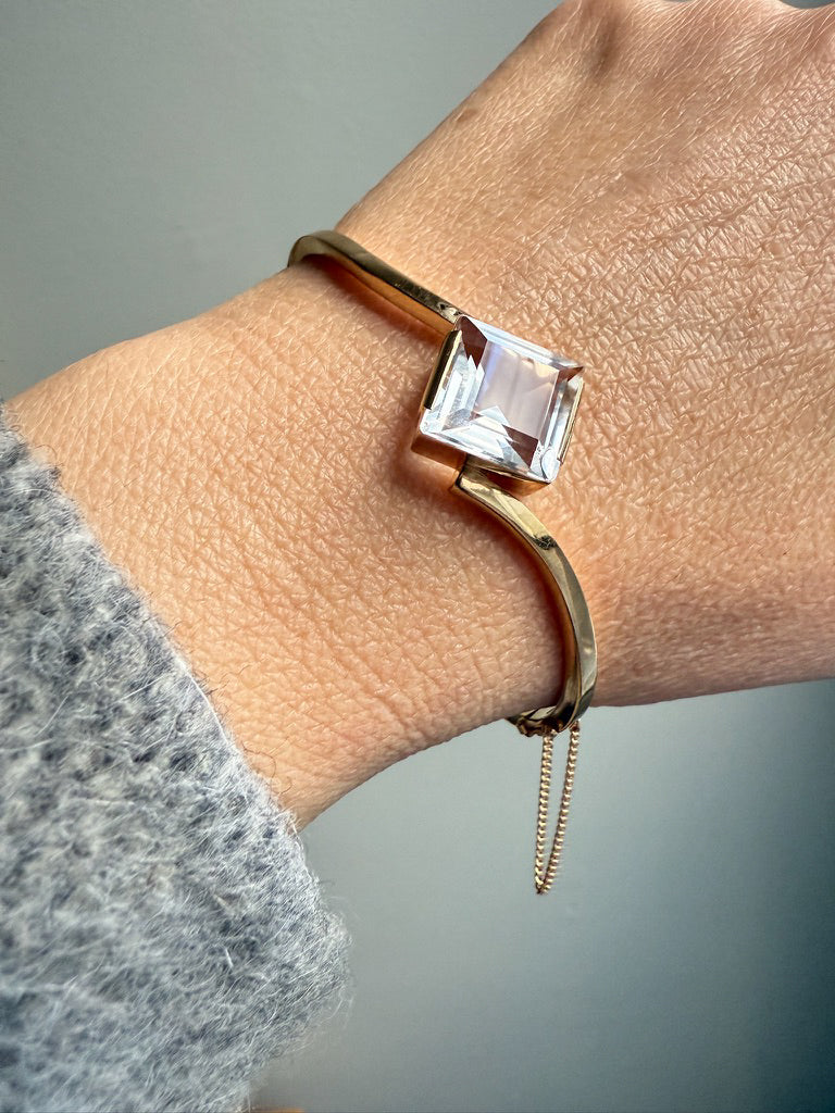 Vintage Gold bracelet with a square gemstone on a wrist against a neutral background. PenelopePenelope.com
