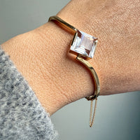 Vintage Gold bracelet with a square gemstone on a wrist against a neutral background. PenelopePenelope.com