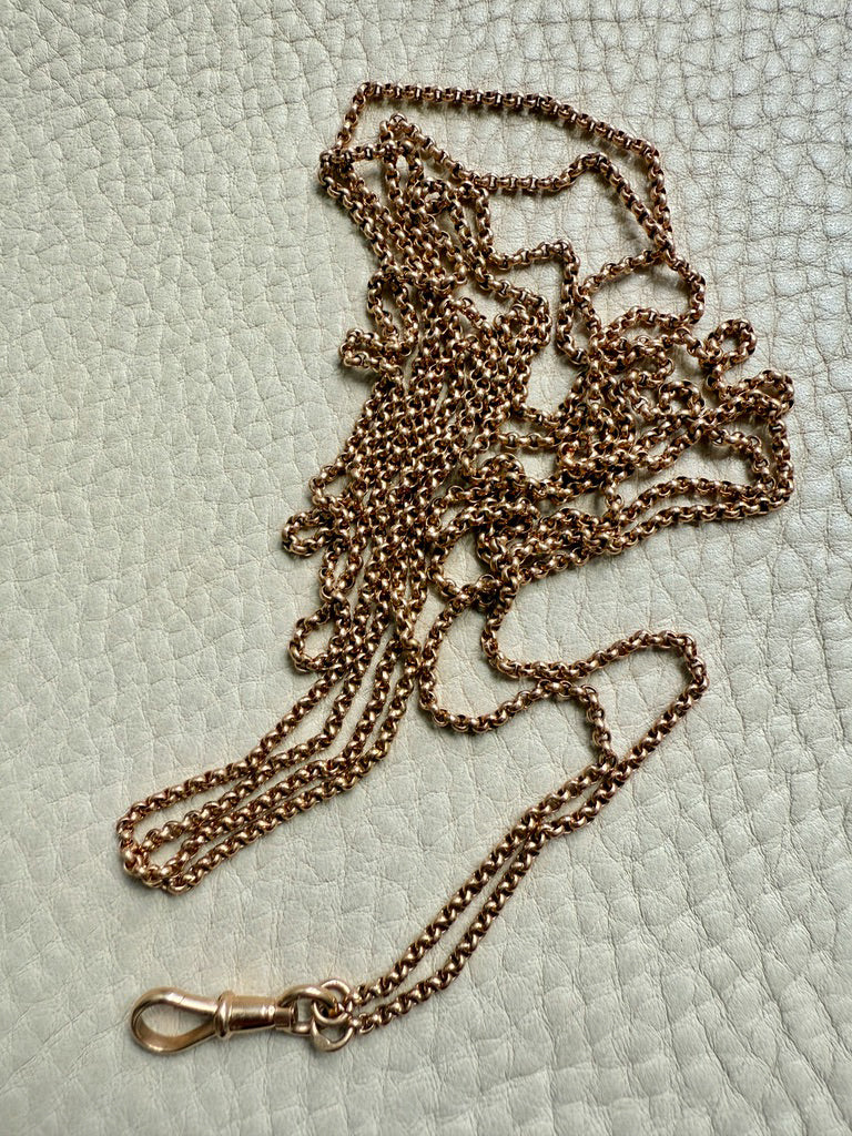 18k gold chain with clasp on a textured light green background Penelope Penelope vintage gold chains